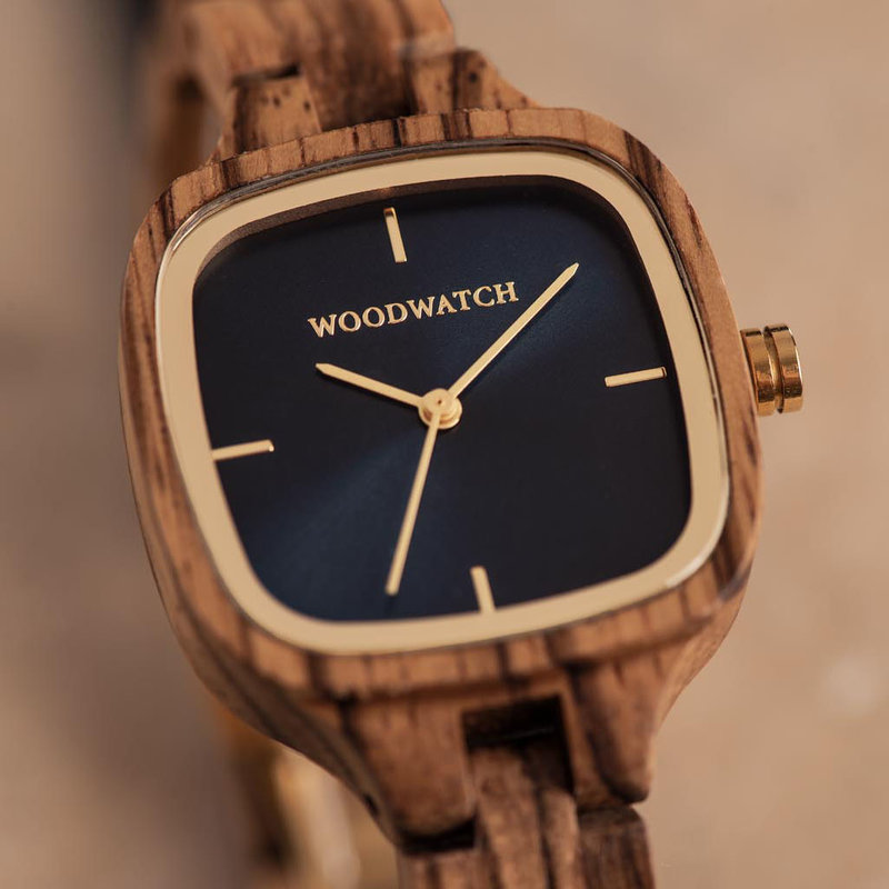 The CITY Skylight features a 30mm square case with a blue dial and golden details. The watch band consists of natural zebra wood that has been hand-finished to perfection and to create our latest small-band design.