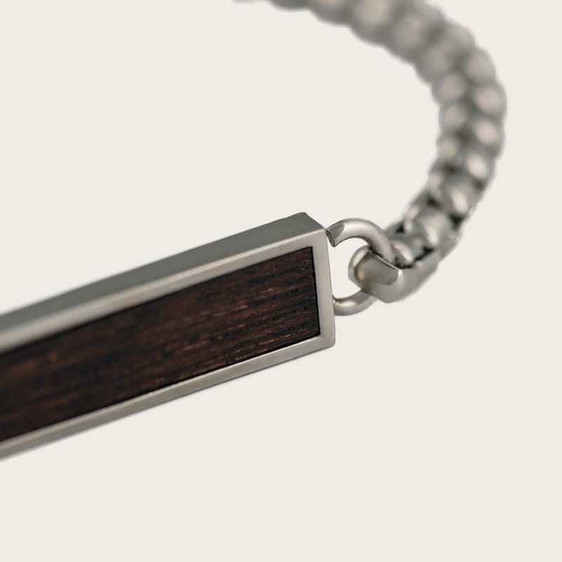 The CHAIN Dark Pine & Silver features classic chain design with a rectangular pendant. It comes in a brass silver colored finishing with dark pinewood. Pair it seamlessly with your WoodWatch or wear it by itself for a minimalistic look. The bracelet comes
