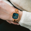 The CITY Atomic features a 30mm square case with a blue dial and golden details. The watch band consists of natural Mahogany wood that has been hand-finished to perfection and to create our latest small-band design.