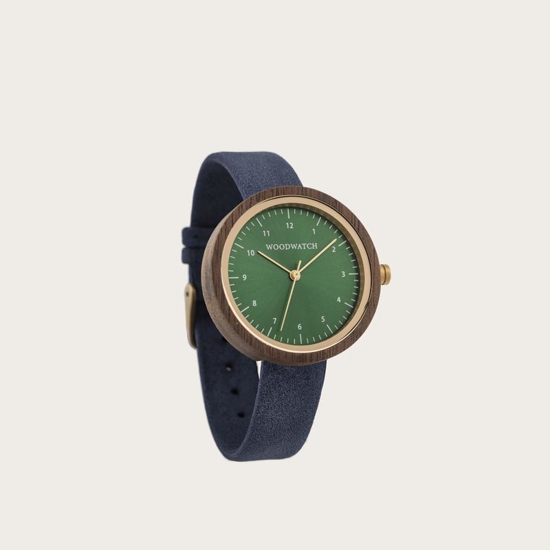 Inspired by contemporary Nordic minimalism. The NORDIC Bergen Navy features a 36mm diameter walnut wood case with a green dial and gold details. Handmade from sustainably sourced wood and combined with an ultra soft blue sustainable vegan leather strap.
