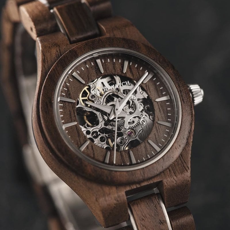 The AUTOMATIC Voyager features a self-winding automatic mechanical movement with 36 hours power reserve. A distinctive optical experience is created through the 33mm case with a silver bezel and partial wooden dial with an open heart, revealing the comple