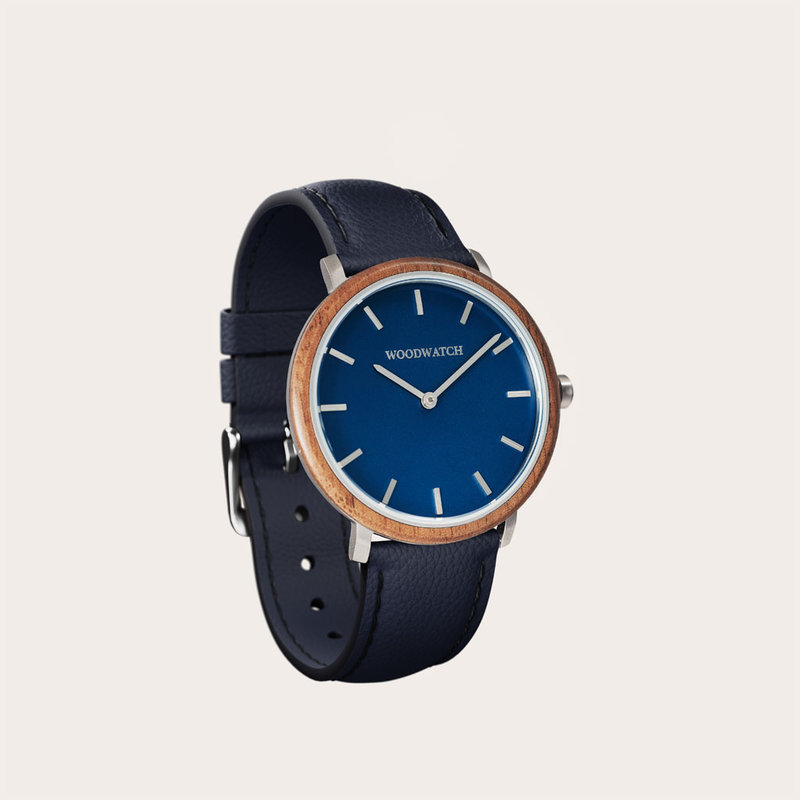 A renewed MINIMAL design with a timeless look that matches any occasion. Featuring a thin, steel case, and walnut bezel and blue dial. Comes with a new watch strap, designed from the ground up to perfectly match the minimal watch case in style and materia