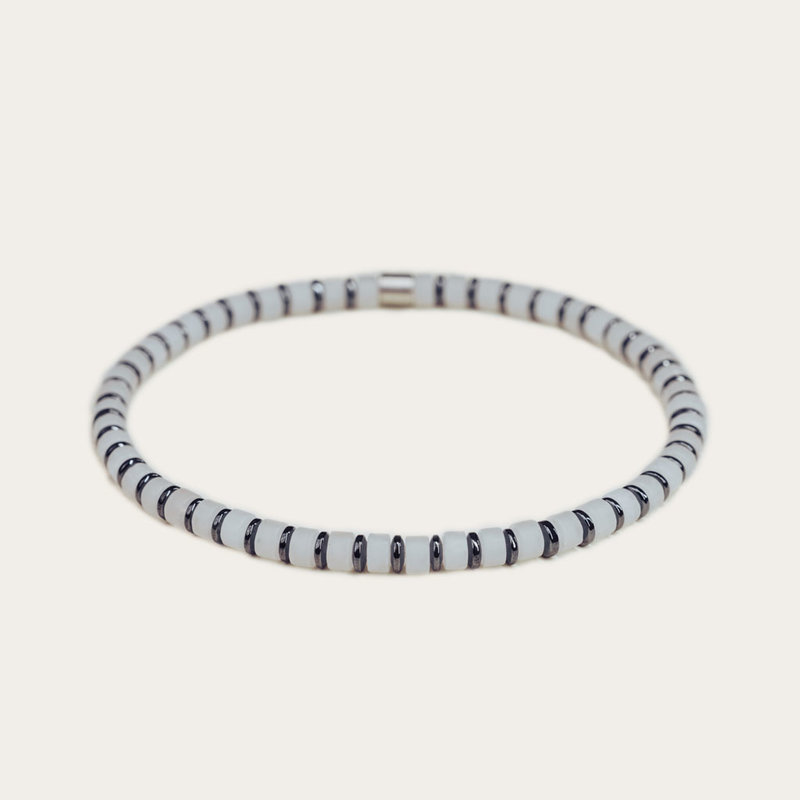 Handmade natural stone bracelet from white jade. Features 4mm sliced beads and a stainless steel accent. Made with a quality stretch cord to easily put it on and take it off.