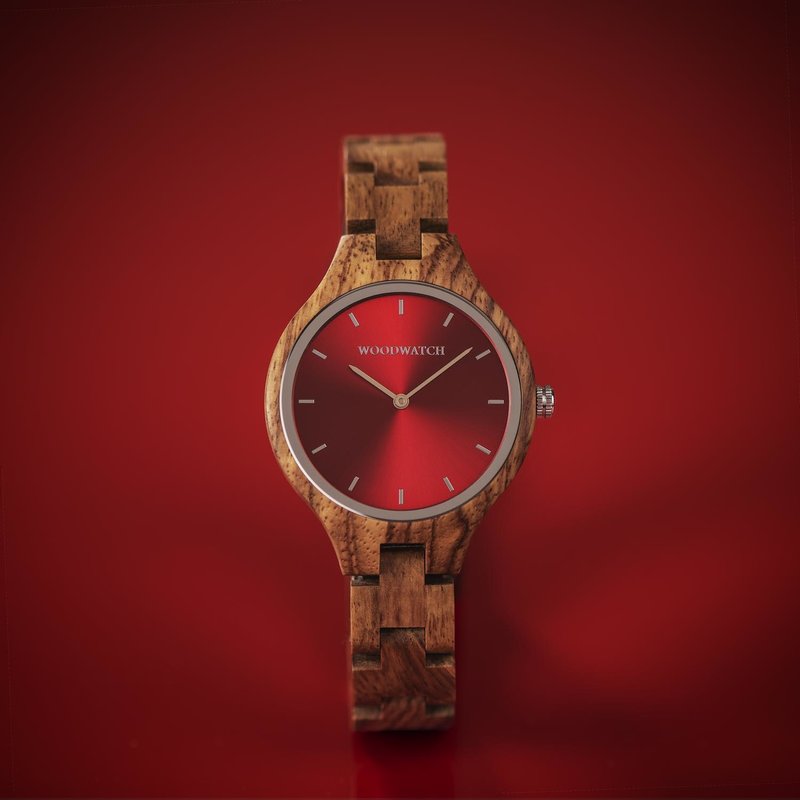 The AURORA Collection breaths the fresh air of Scandinavian nature and the astonishing views of the sky. This light weighing watch is made of kosso wood, accompanied by a red stainless-steel dial. The watch is available with a wooden strap or a leather st