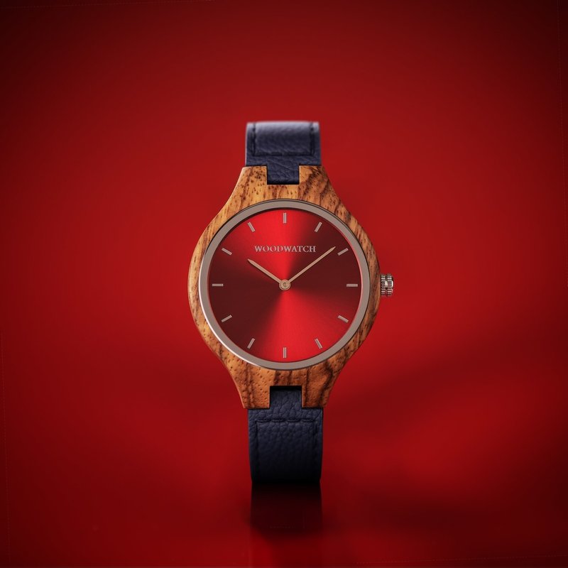 The AURORA Collection breaths the fresh air of Scandinavian nature and the astonishing views of the sky. This light weighing watch is made of kosso wood, accompanied by a red stainless-steel dial. Comes with a cactus leather strap in matching navy blue, e