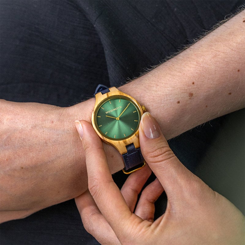 The AURORA Collection breaths the fresh air of Scandinavian nature and the astonishing views of the sky. This light weighing watch is made of olive wood, accompanied by a green stainless-steel dial with golden details.<br />
Comes with a cactus leather strap i