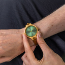 The AURORA Collection breaths the fresh air of Scandinavian nature and the astonishing views of the sky. This light weighing watch is made of olive wood, accompanied by a green stainless-steel dial with golden details.<br />
Comes with a cactus leather strap in