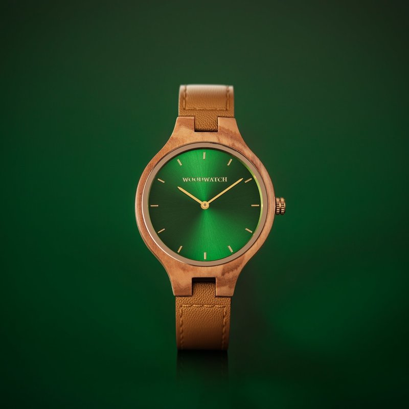 The AURORA Collection breaths the fresh air of Scandinavian nature and the astonishing views of the sky. This light weighing watch is made of olive wood, accompanied by a green stainless-steel dial with golden details.<br />
Comes with a cactus leather strap in