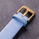 The Selene Azure Frost is crafted from walnut wood, featuring a white dial, light blue vegan strap, and golden details.