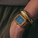 The Elegance Midnight Shade is crafted from walnut wood and stainless steel, featuring a navy blue dial with brushed gold metal details.