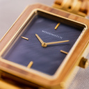 The Elegance Blue Pearl is crafted from olive wood and stainless steel, featuring a blue mother-of-pearl dial with brushed gold metal details.