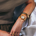 The Radiance Ivory Pearlworld is crafted from olive wood and stainless steel brushed gold, featuring a pearl white dial and brushed gold metal details.
