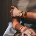 The Radiance Ivory Pearlworld is crafted from olive wood and stainless steel brushed gold, featuring a pearl white dial and brushed gold metal details.