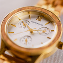 The Radiance Ivory Pearlworld is crafted from olive wood and stainless steel brushed gold, featuring a pearl white dial and brushed gold metal details.
