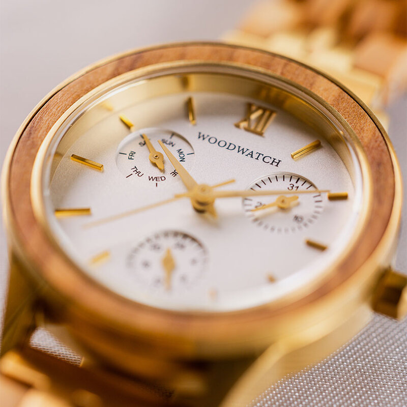 The Radiance Ivory Pearlworld is crafted from olive wood and stainless steel brushed gold, featuring a pearl white dial and brushed gold metal details.