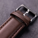 The Nostalgia Espresso is crafted from walnut wood and stainless steel, featuring a matte blue dial, dark brown vegan leather strap, and brushed silver metal details.