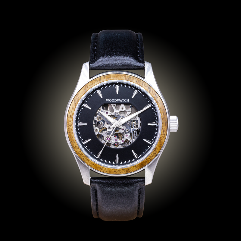 The Nostalgia Jet is crafted from walnut wood and stainless steel, featuring a matte black dial, black vegan leather strap, and brushed silver metal details.
