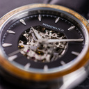 The Nostalgia Jet is crafted from walnut wood and stainless steel, featuring a matte black dial, black vegan leather strap, and brushed silver metal details.