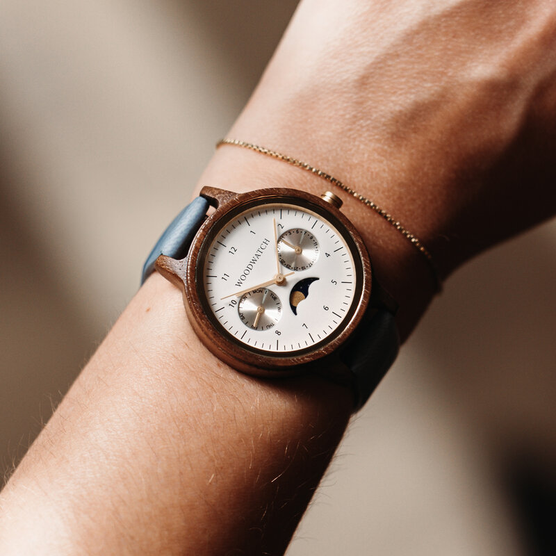 The Selene Azure Frost is crafted from walnut wood, featuring a white dial, light blue vegan strap, and golden details.