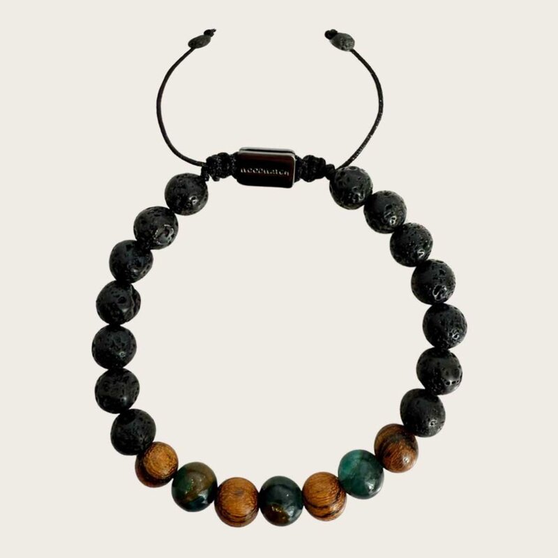 Made with rosewood beads, volcanic beads, dark green natural stone beads, and a matte black brass closure. Adjustable, with 8mm beads to fit most wrist sizes.