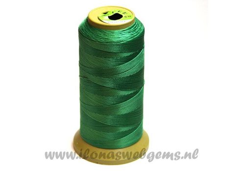 Large roll of beading thread green