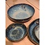 artisann In the mold laid round dish of Belgian clay with a beautiful Floating blue highly fired glaze.