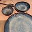 artisann In the mold laid round dish of Belgian clay with a beautiful Floating blue highly fired glaze.