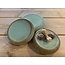 artisann With the turntable handmade presentation stone of Englisch speckled Pottery Clay with a beautiful Floating lightblue turkis high-firing glaze.