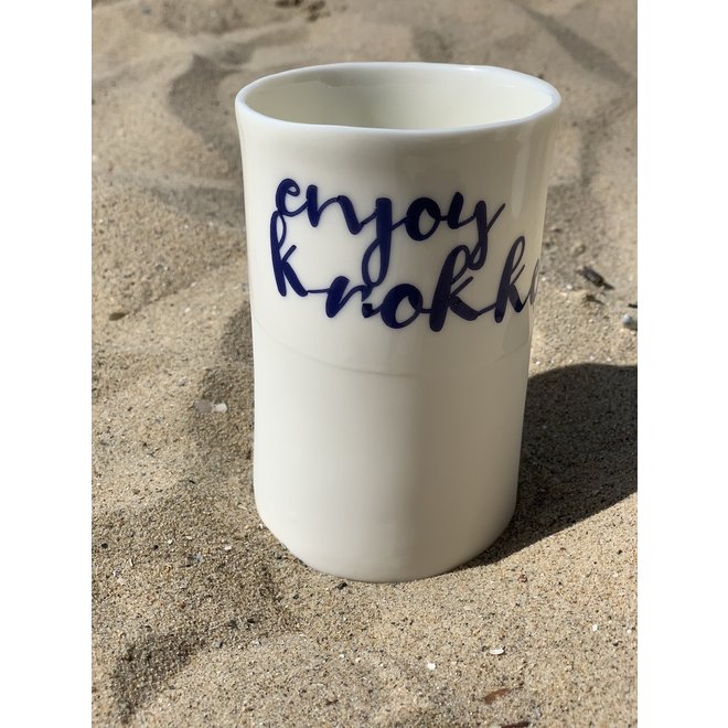 "Enjoy Knokke" with a transfer baked on a porcelain handmade bag, drinking cup, vase