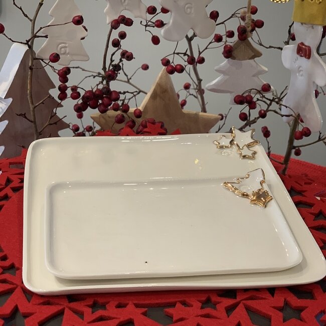 Porcelain handmade Christmas service with accents of golden stars and a Christmas tree