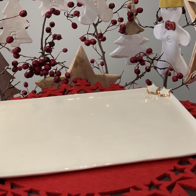 Porcelain handmade Christmas service with accents of golden stars and a Christmas tree