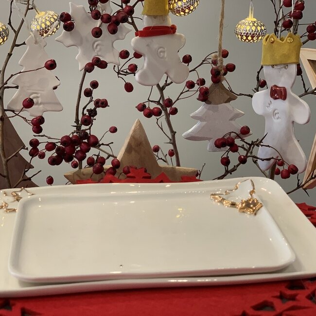 Porcelain handmade Christmas service with accents of golden stars and a Christmas tree