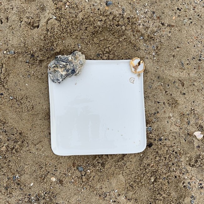 Handmade plate in white porcelain with a shiny transparent glaze finished with a golden shell