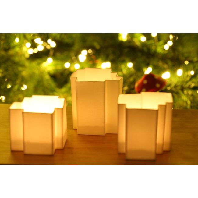 K-design Gift package of three white porcelain tea lights made in a puzzle shape that can be combined beautifully and uniquely together