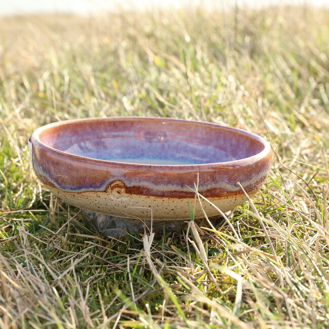 With the turntable handmade scale of Pyerite clay with a beautiful floating magenta, rose high-firing glaze.