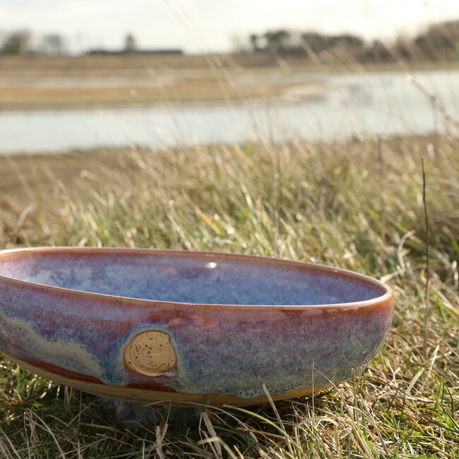 With the turntable handmade scale of Pyerite clay with a beautiful floating magenta, rose high-firing glaze.