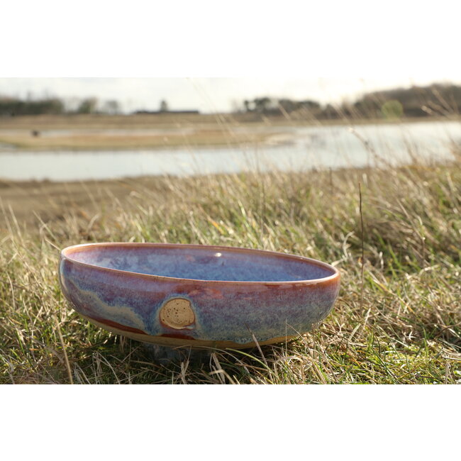 With the turntable handmade scale of Pyerite clay with a beautiful floating magenta, rose high-firing glaze.