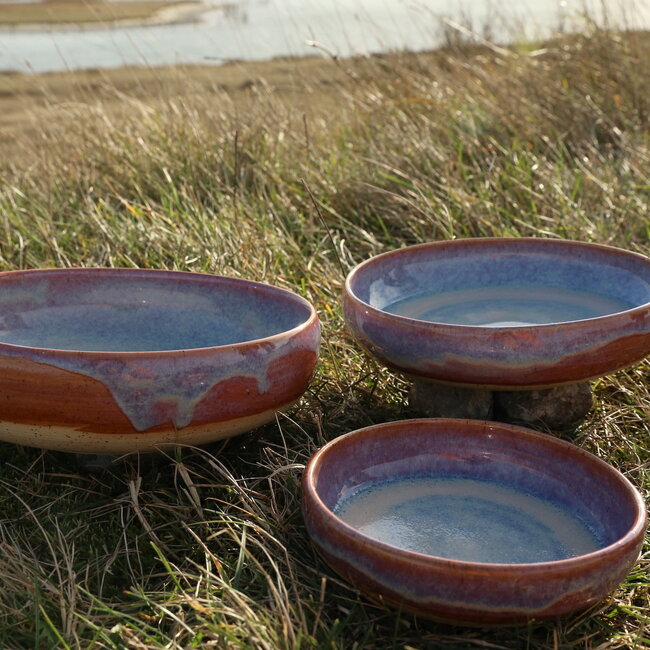 With the turntable handmade scale of Pyerite clay with a beautiful floating magenta, rose high-firing glaze.