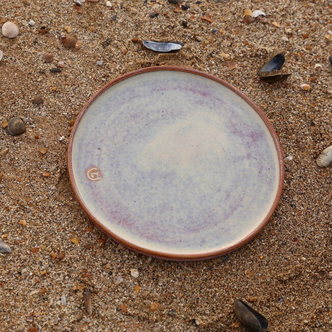 With the turntable handmade plate with speckled Pyerite clay and a beautiful magenta,rose high firing glaze.