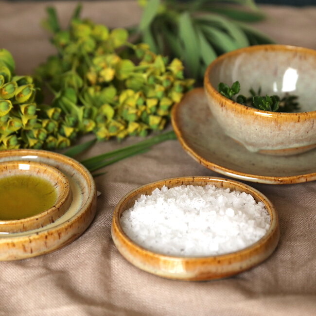 Handmade small ceramic oil dish with the turntable in a beautiful yellow glaze