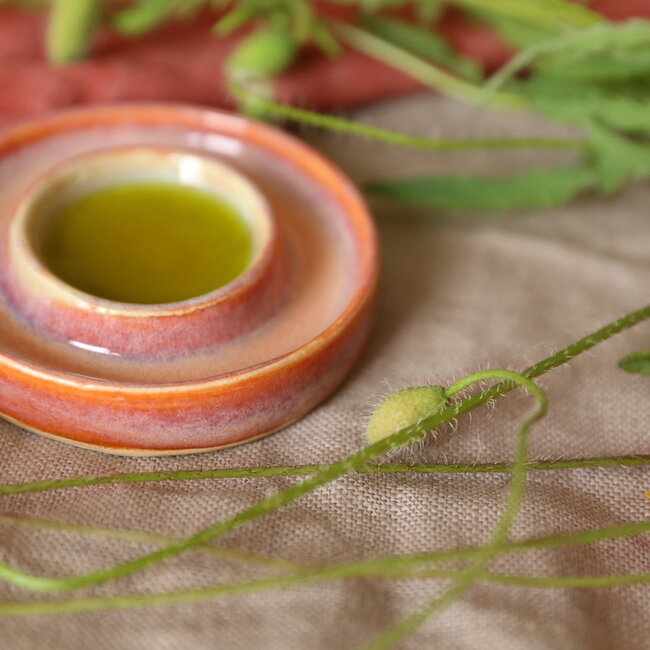 Handmade small ceramic oil dish with the turntable in a beautiful orange glaze