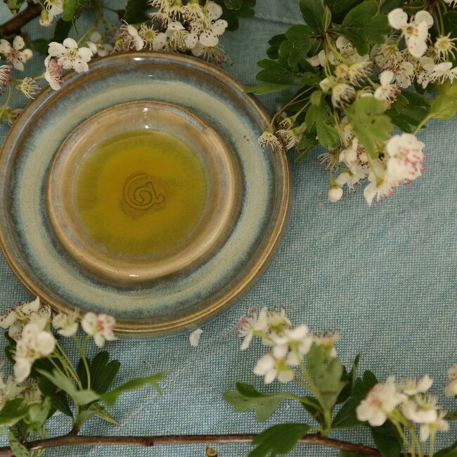 Handmade small ceramic oil dish with the turntable in a beautiful green mintglaze