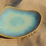 This unique shell-shaped plate has a functional medium-sized presentation bottom and very original in presentation for the chef