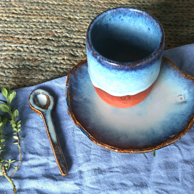 With the turntable handmade cup of Belgien red clay with a beautiful floating blue high firing glaze.