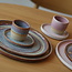 With the turntable handmade plate with speckled Pyerite clay and a beautiful magenta,rose high firing glaze.