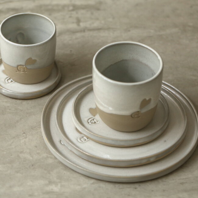 Handmade white ceramic plate from the tableware and collection “White Love" with a little heart
