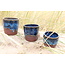 artisann With the turntable handmade cup of Belgien red clay with a beautiful floating blue high firing glaze.