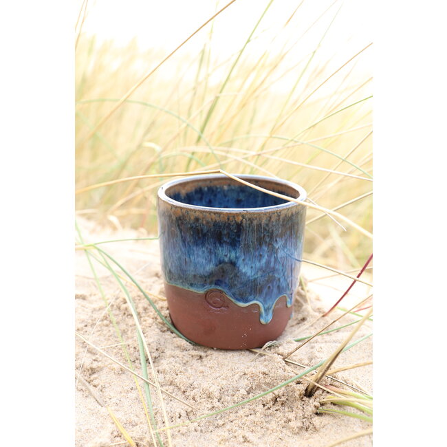 artisann With the turntable handmade cup of Belgien red clay with a beautiful floating blue high firing glaze.