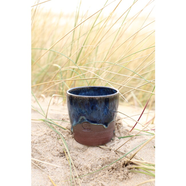 artisann With the turntable handmade cup of Belgien red clay with a beautiful floating blue high firing glaze.