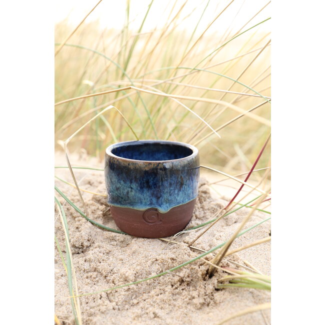 artisann With the turntable handmade cup of Belgien red clay with a beautiful floating blue high firing glaze.